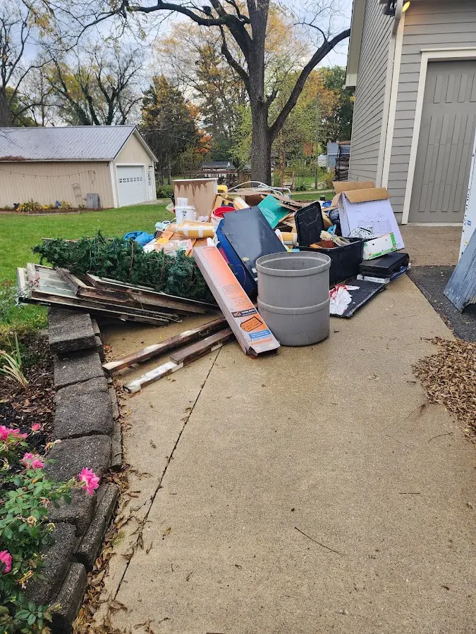 Dumpster being loaded with debris for Residential Dumpster Rental in Plainfield